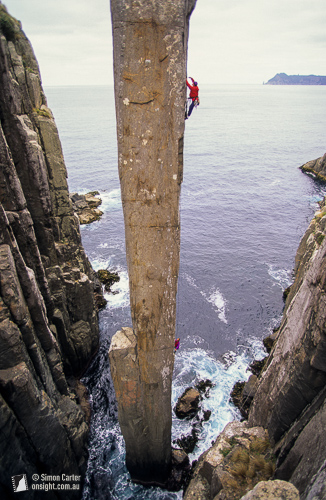 Steve Monks aid climbing The Totem Pole with Simon Mentz belaying, in 1995. This was then was the only route up the Totem Pole – until the pair returned a few days later and established the Free Route. Cape Hauy, Tasmania, Australia.