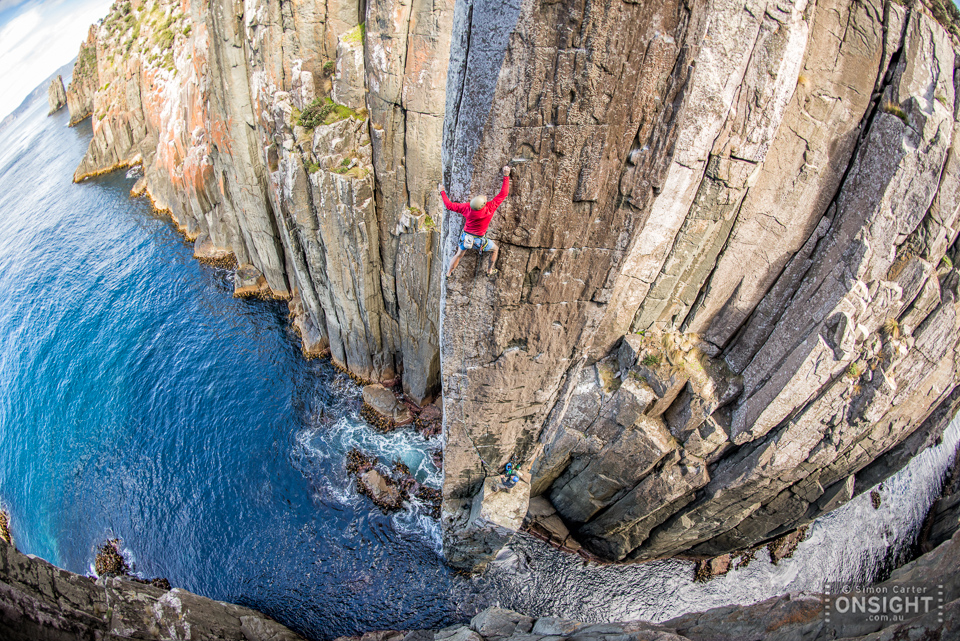 Chris Coppard on The Sorcerer (27) with Garry Phillips belaying, a new independant route that they established on the Totem Pole in 2015 -- some 20 years after the first free ascent of the 65m high pillar. Cape Hauy, Tasman Peninsular, Tasmania, Australia.
